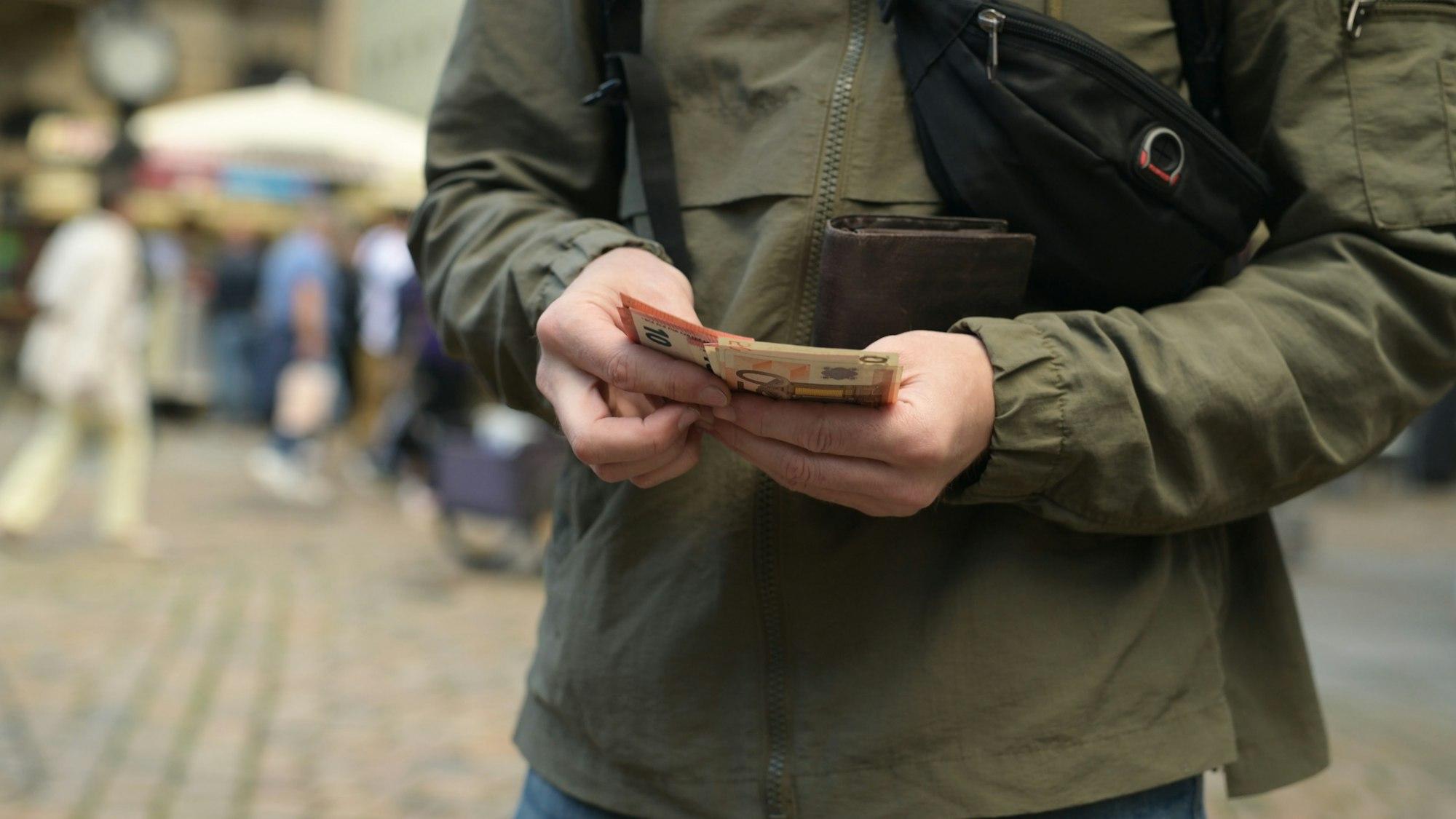 Man On Street Pulls Out Euro From Wallet